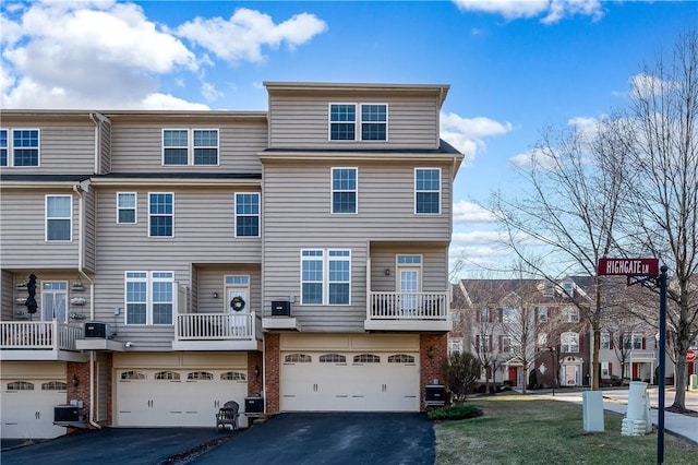 view of property with brick siding, cooling unit, an attached garage, and aphalt driveway