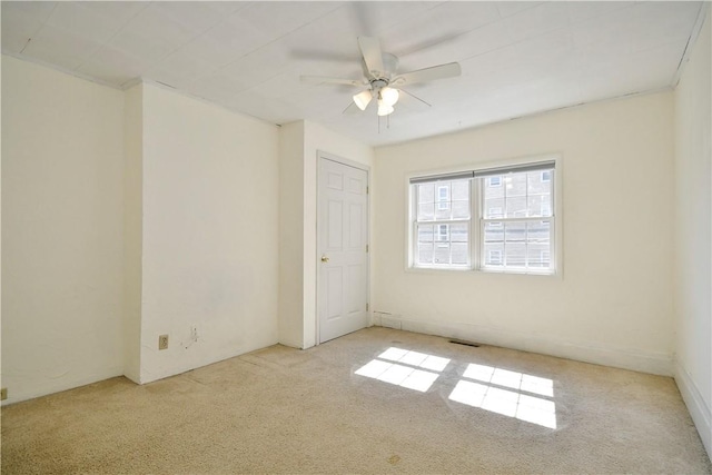 unfurnished room featuring visible vents and a ceiling fan