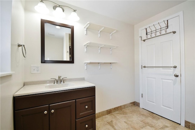 bathroom with vanity and baseboards