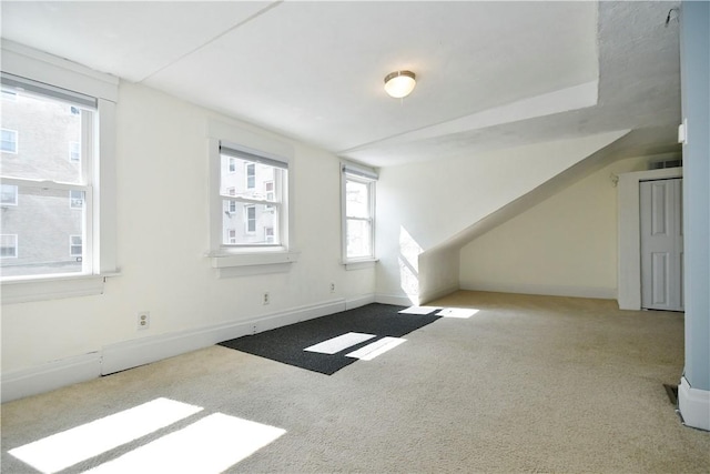 additional living space featuring carpet flooring and baseboards