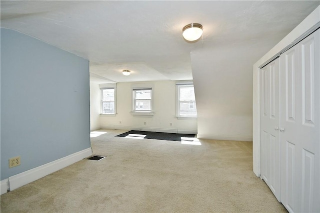 empty room with visible vents, baseboards, and carpet flooring