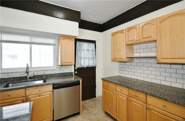 kitchen featuring dishwasher, tasteful backsplash, light brown cabinetry, and a sink