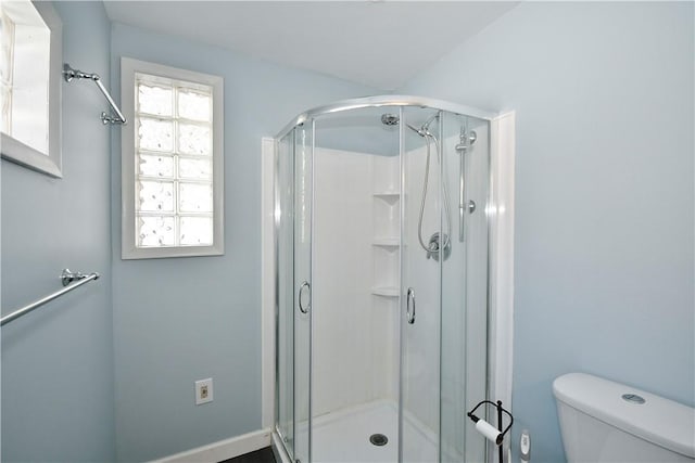 full bathroom with toilet and a shower stall