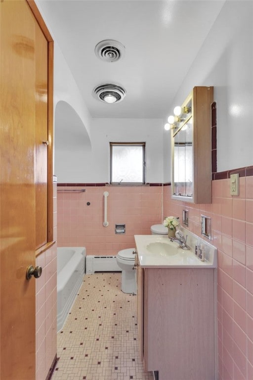 bathroom featuring a tub, a baseboard radiator, toilet, and visible vents