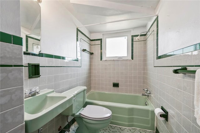 full bath featuring a sink, toilet, tile walls, and shower / bathtub combination