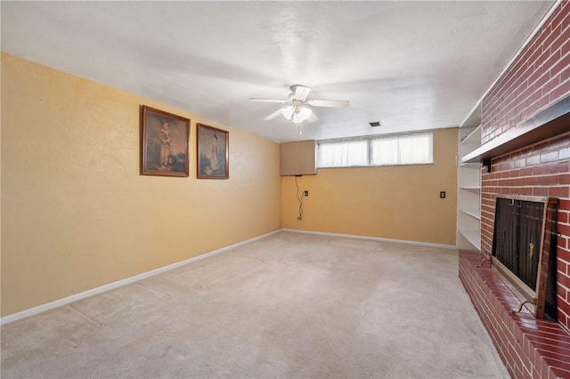 unfurnished living room with a ceiling fan, a fireplace, baseboards, and light carpet