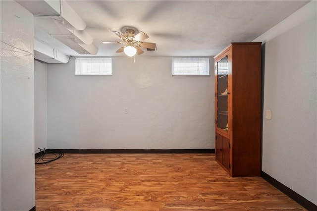 basement featuring wood finished floors and baseboards