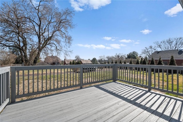 wooden deck with a lawn