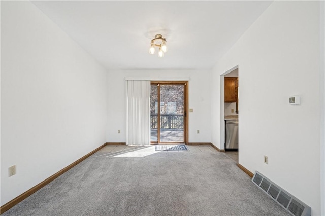 spare room featuring light carpet, visible vents, and baseboards