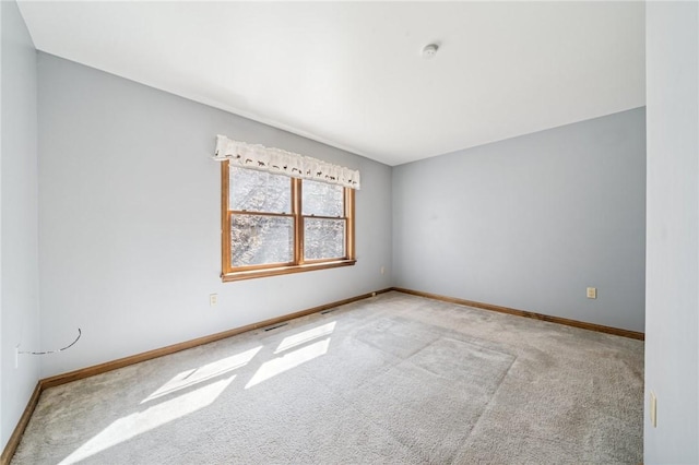 unfurnished room featuring baseboards and carpet flooring