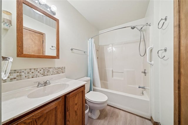 full bathroom with vanity, shower / bathtub combination with curtain, wood finished floors, decorative backsplash, and toilet