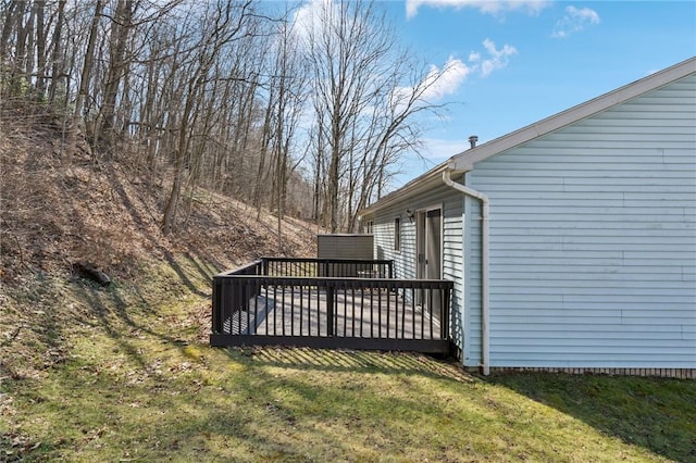 wooden deck featuring a lawn