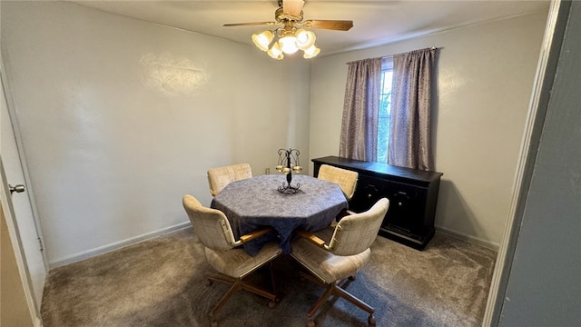 carpeted dining space featuring baseboards and ceiling fan