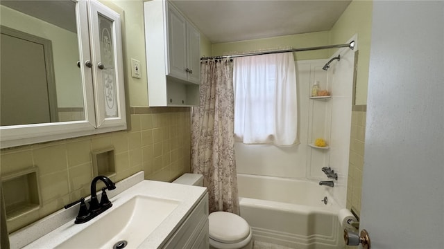 bathroom featuring tile walls, toilet, vanity, and shower / bath combo