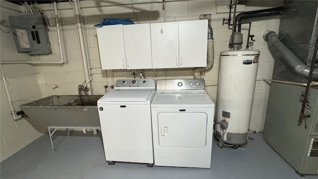 laundry room featuring concrete block wall, electric panel, cabinet space, water heater, and washing machine and dryer