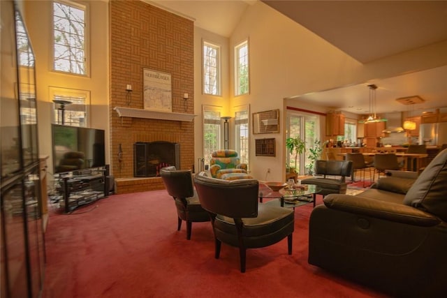 carpeted living area with a towering ceiling and a fireplace