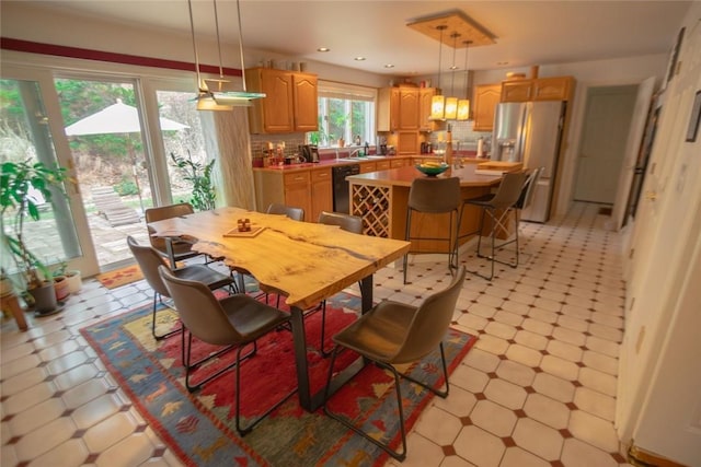 dining area featuring recessed lighting and light floors