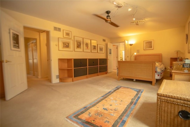 bedroom featuring visible vents, ceiling fan, and carpet flooring