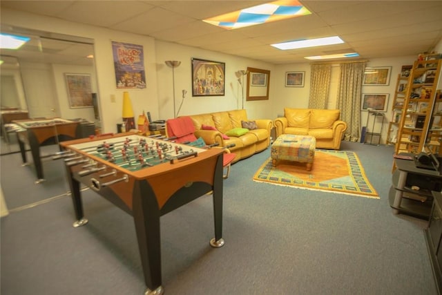 rec room with a drop ceiling and carpet flooring