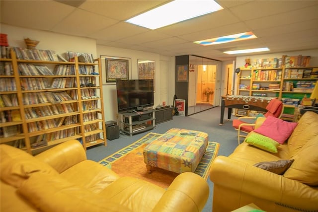 living area with a drop ceiling