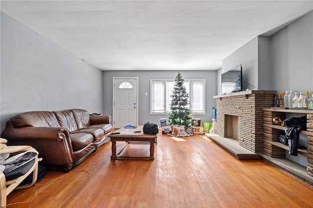 living area with a fireplace and hardwood / wood-style flooring