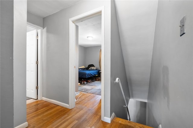 stairway with hardwood / wood-style flooring and baseboards