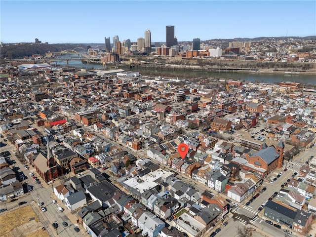 birds eye view of property with a city view and a water view