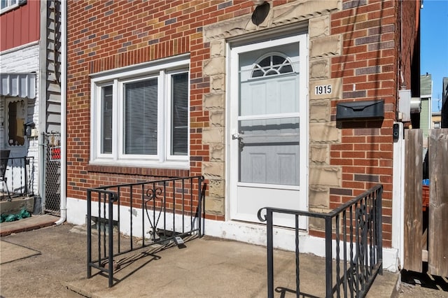 property entrance featuring brick siding