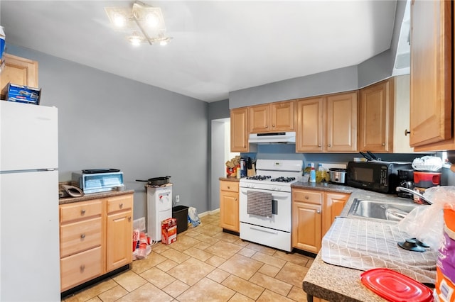 kitchen featuring white appliances, light brown cabinetry, a sink, light countertops, and under cabinet range hood