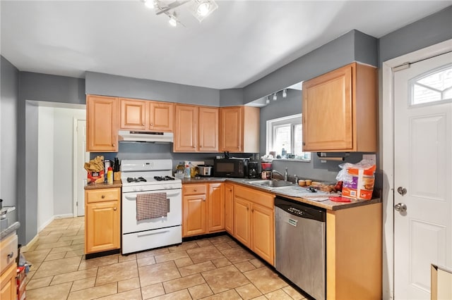 kitchen with gas range gas stove, a sink, black microwave, under cabinet range hood, and dishwasher