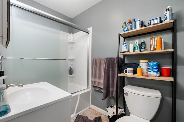 full bath featuring tile patterned floors, shower / bath combination with glass door, toilet, and a sink