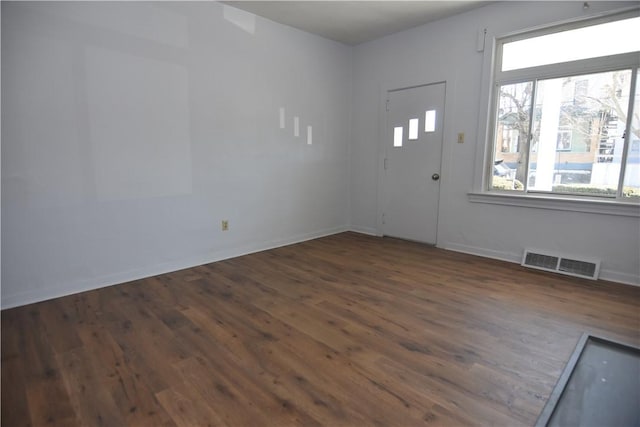 entrance foyer featuring wood finished floors, visible vents, and baseboards