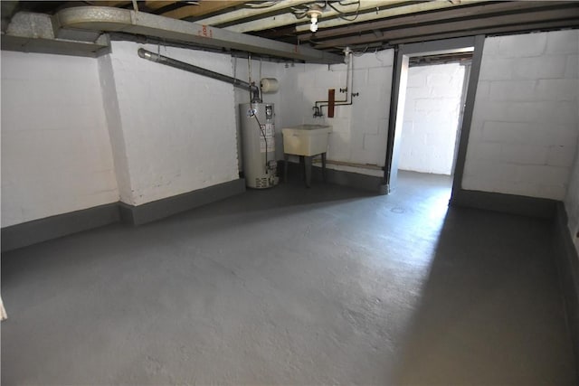 basement featuring gas water heater and a sink