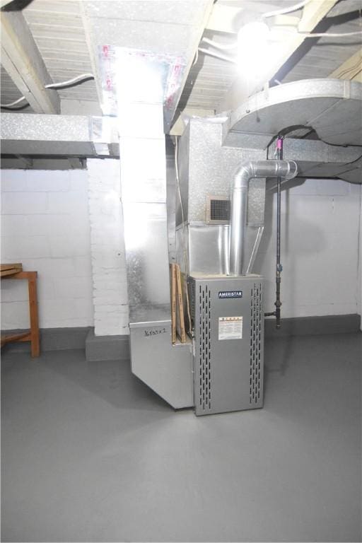 utility room featuring heating unit