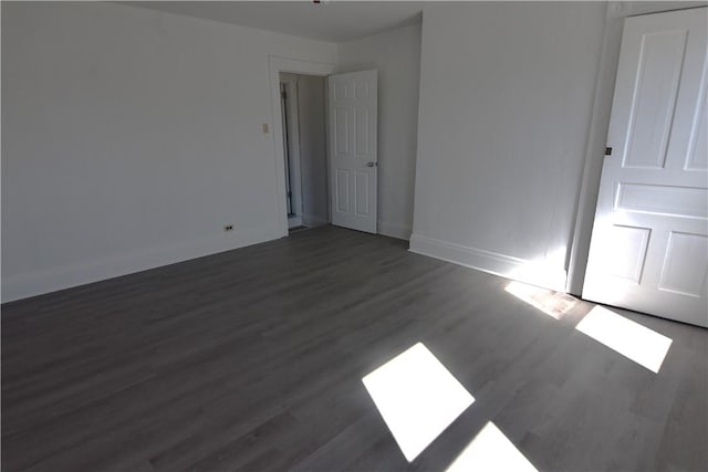 interior space featuring baseboards and wood finished floors