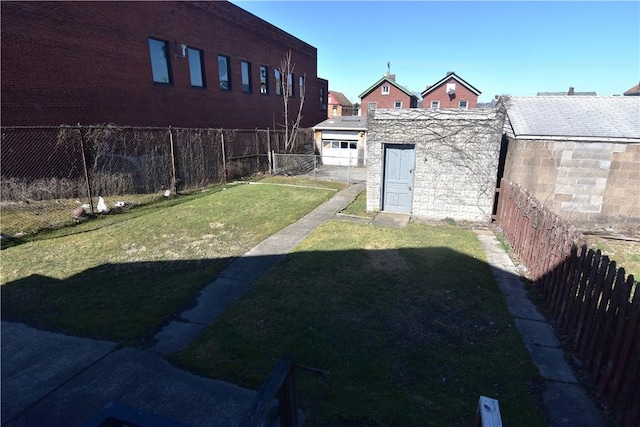 view of yard with an outbuilding and a fenced backyard