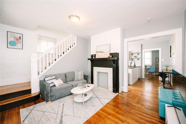 living area featuring stairway and wood-type flooring