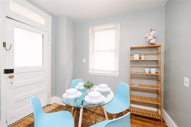 dining space with wood finished floors and baseboards