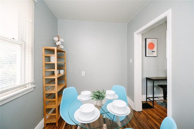 dining area featuring baseboards and wood finished floors