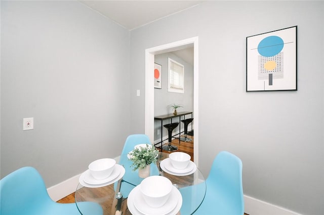 dining area with wood finished floors and baseboards