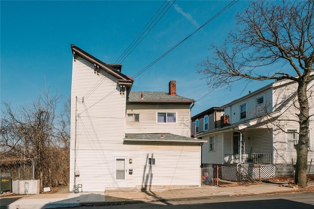 back of property featuring a chimney