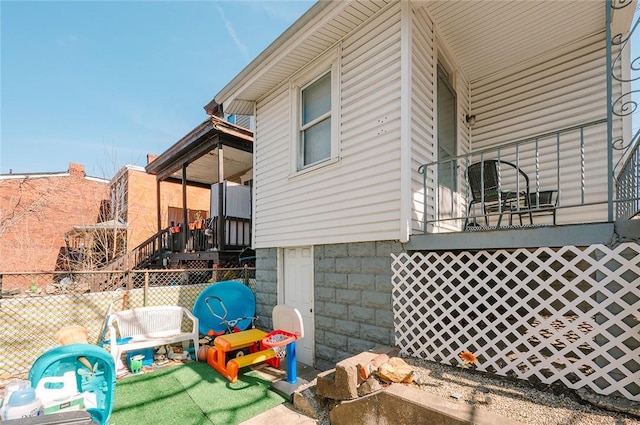 view of side of home featuring fence