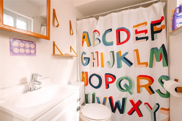 bathroom with vanity, toilet, and a shower with curtain