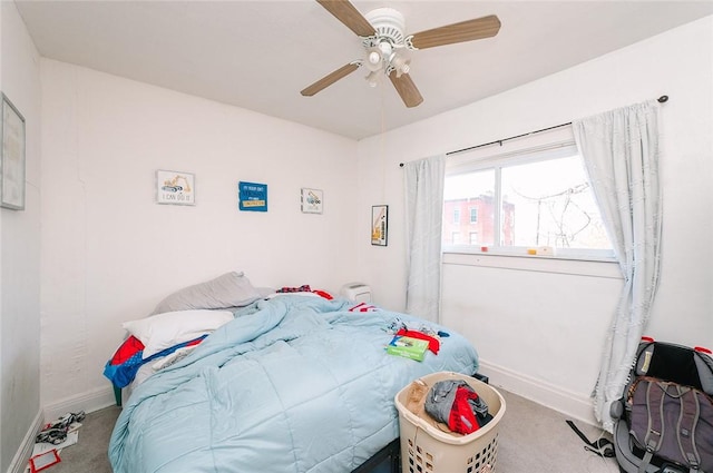 bedroom featuring baseboards, carpet floors, and a ceiling fan