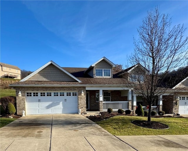 craftsman house with a porch, a shingled roof, concrete driveway, a garage, and brick siding