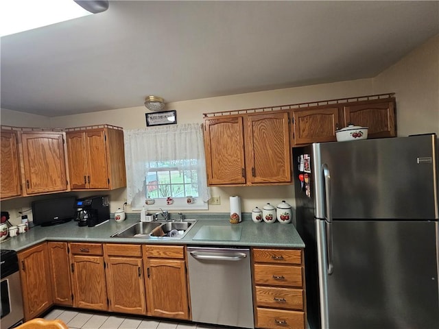 kitchen with a sink, stainless steel appliances, and brown cabinets