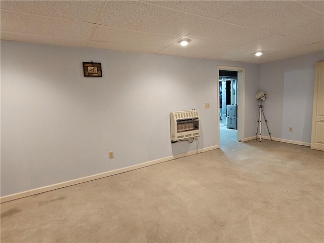 unfurnished room featuring a drop ceiling, heating unit, recessed lighting, carpet flooring, and baseboards