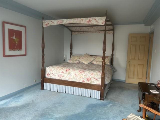 carpeted bedroom with ornamental molding