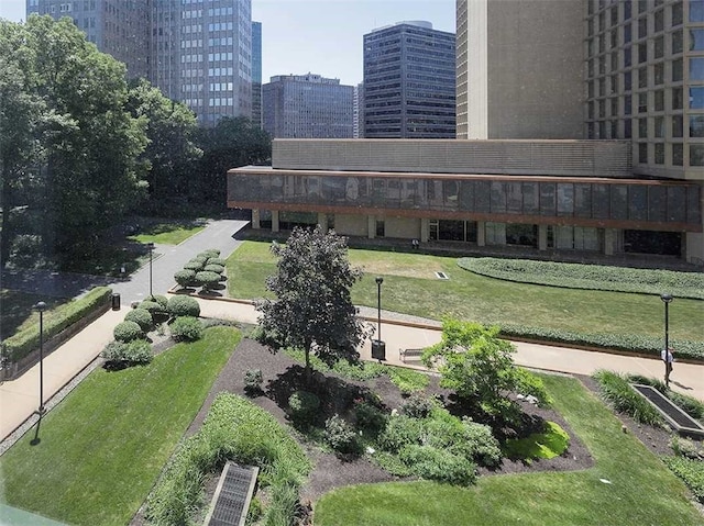 view of property's community featuring a view of city and a yard