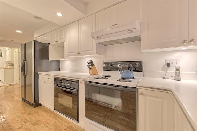 kitchen with oven, light countertops, electric stove, under cabinet range hood, and white cabinetry